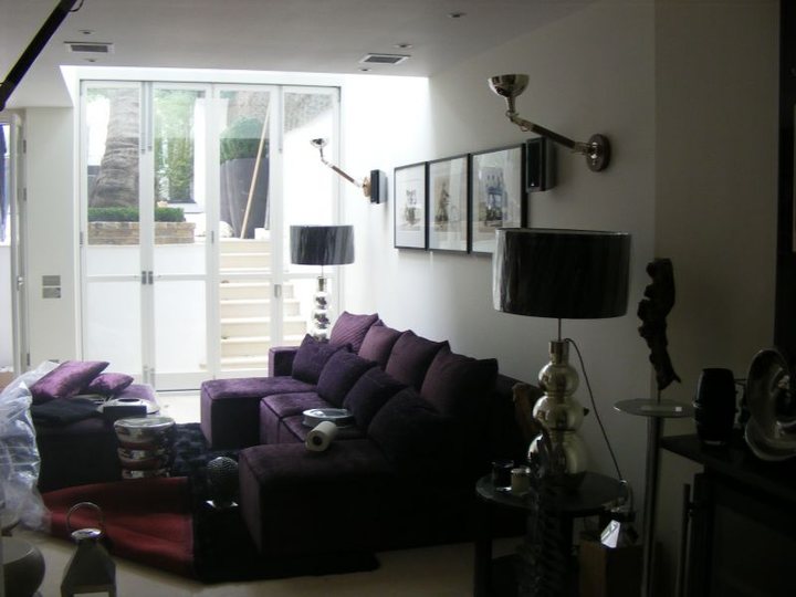 Finished living room with crisp white walls and dark feature furnishings